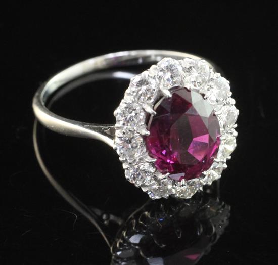 An 18ct white gold and platinum, ruby and diamond cluster ring, size S.
